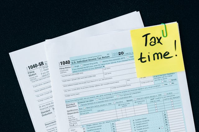 Documents with a yellow note that says "Tax time!"